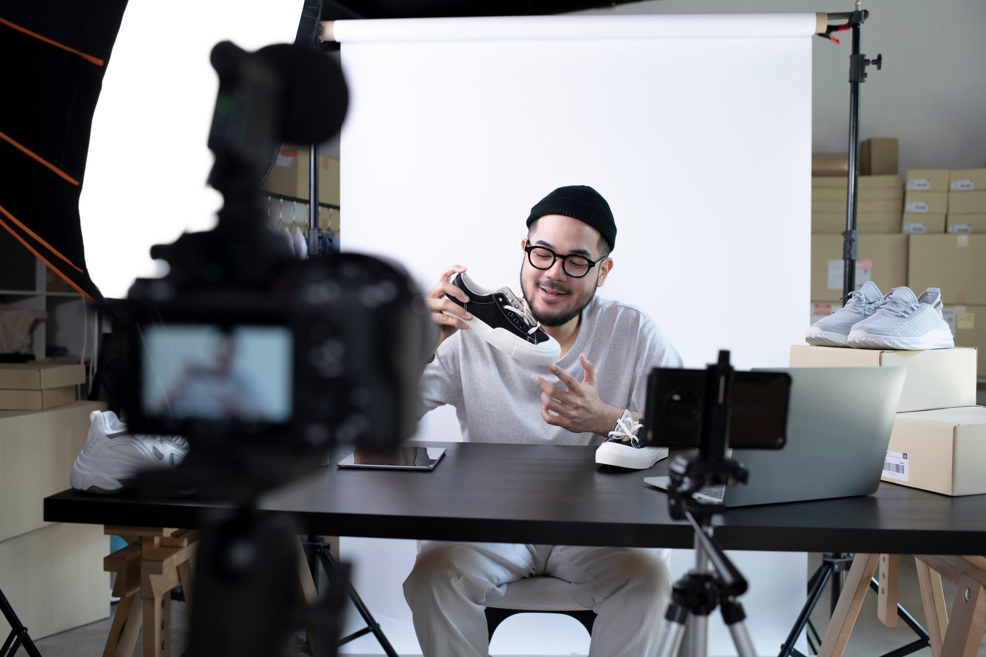 Asian man blogger or vlogger looking at camera reviewing product.